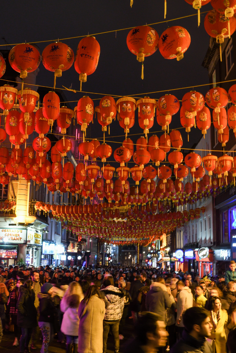 Chinatown celebrating Chinese New Year with a crowd under lantern decorations