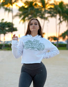 Love Fitness State of Aloha hoodie sweatshirt cropped with model on beach during sunset showing the drawstrings and fit of the oversized hoodie. Palm trees in the background.