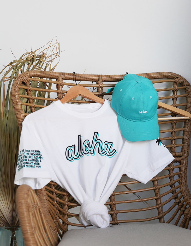 Aloha Everyday white tee paired with the aloha dad hat in teal