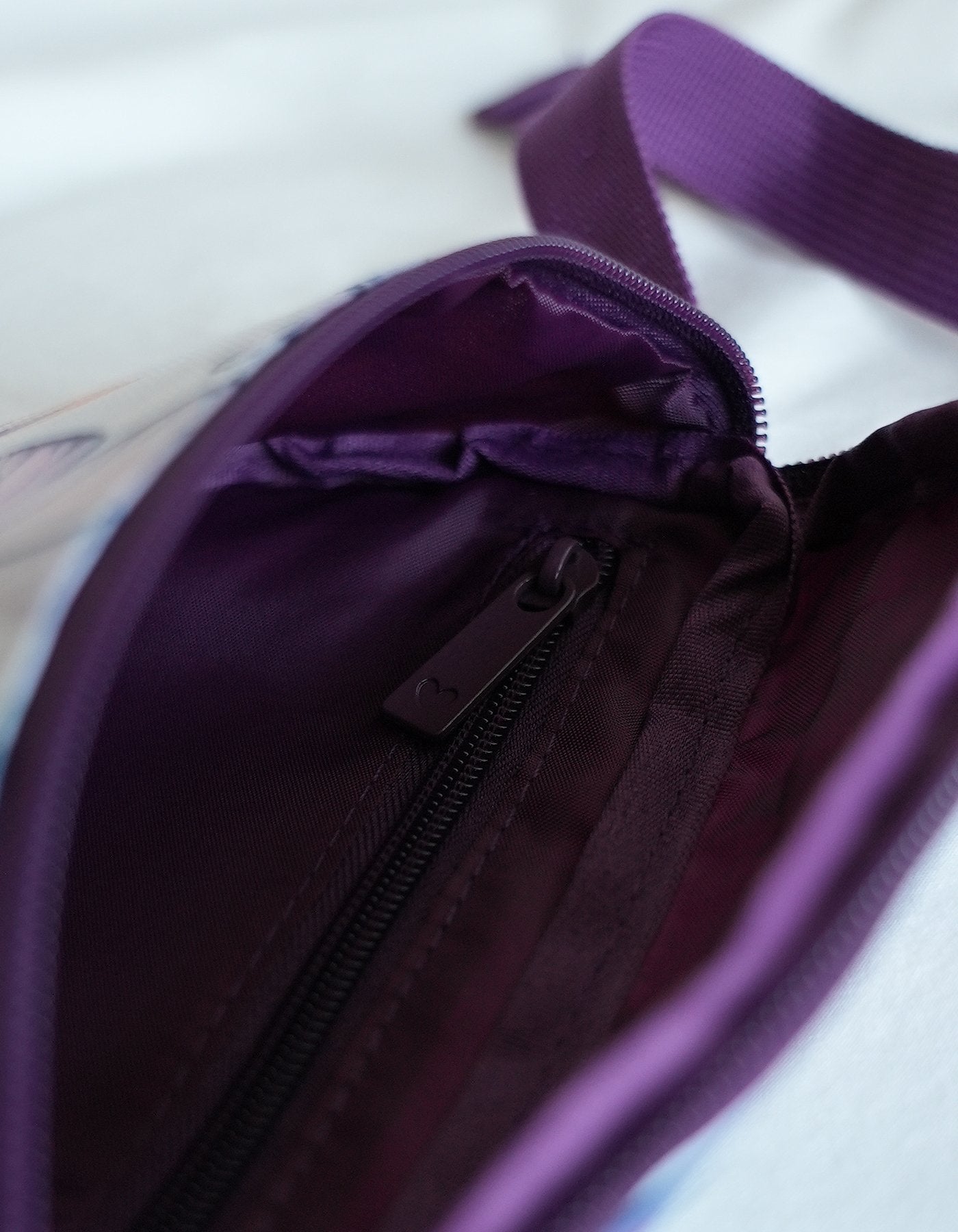 Perfect sized Love Fitness Island Dreams Fanny Pack with an all over print with island flowers and butterflies. Straps in a dark purple and compartment that fits all the on the go essentials