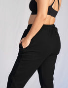 Love Fitness Phaedra Joggers in the color black. Waffle texture with pockets and drawstring to adjust the waistband.