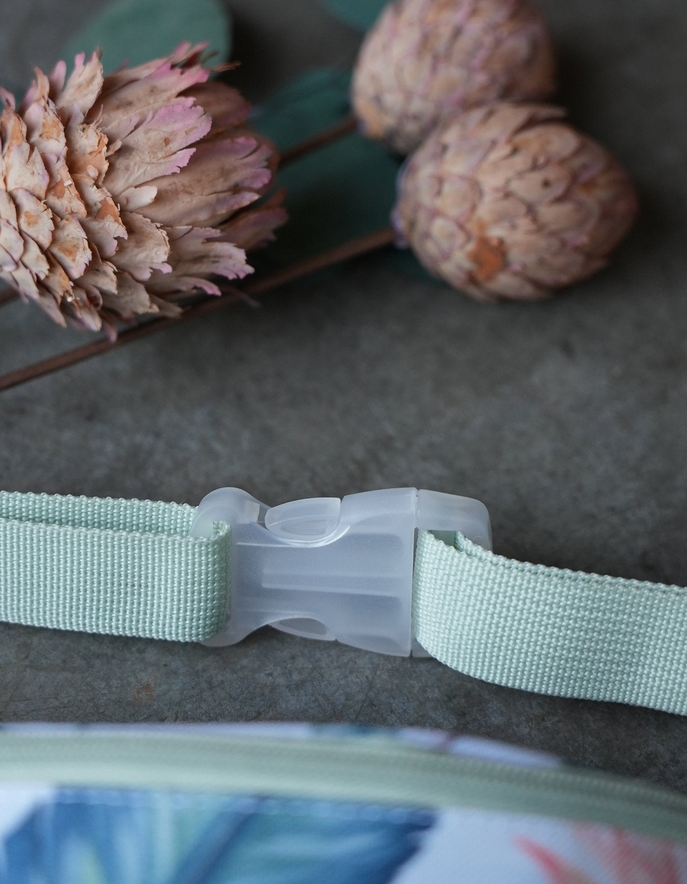 Detailing on the Love Fitness Tropical Paradise Fanny packet strap hardware that is clear and adjustable