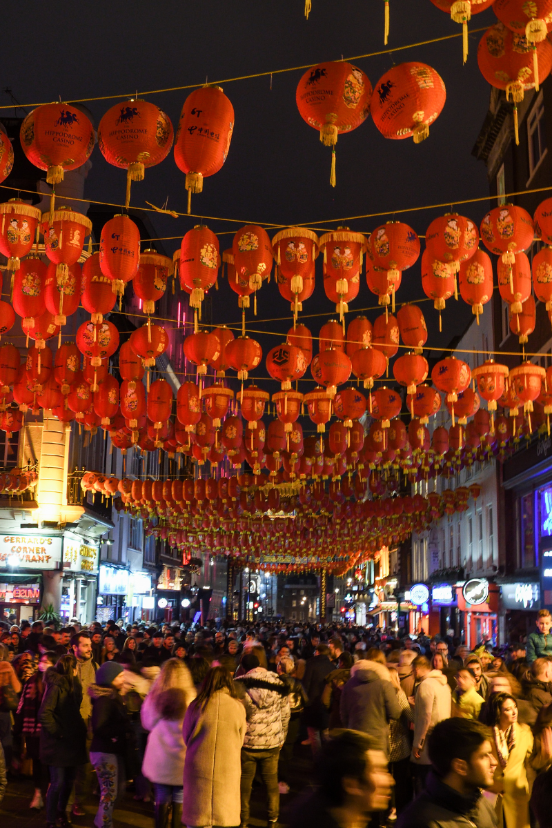 Chinatown celebrating Chinese New Year with a crowd under lantern decorations