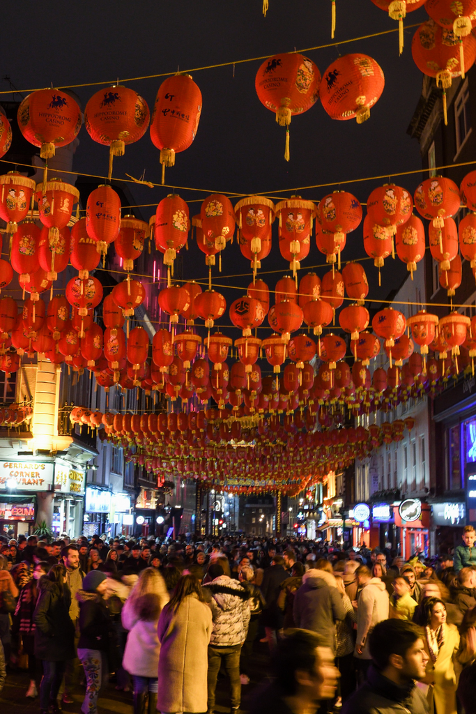 Chinatown celebrating Chinese New Year with a crowd under lantern decorations