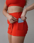 Love Fitness Breeze Shorts in the colors Fiery. Running shorts with hidden pockets underneath