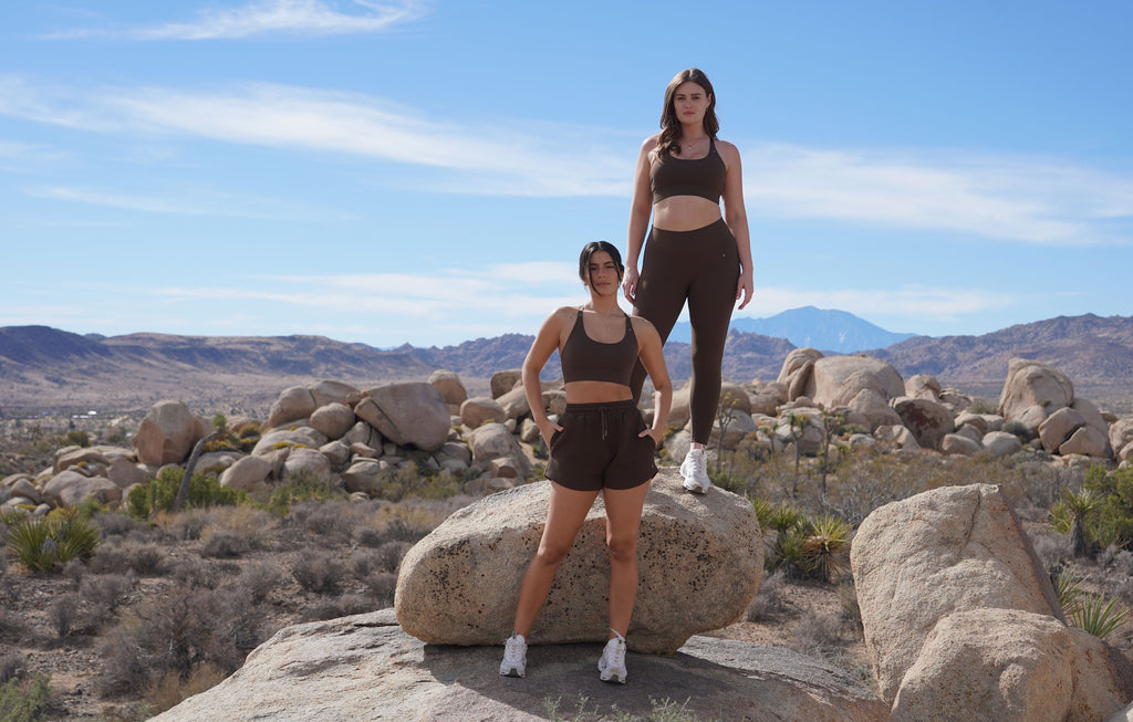 Get to know us. 2 diverse models standing on rocks featuring the sedona collection