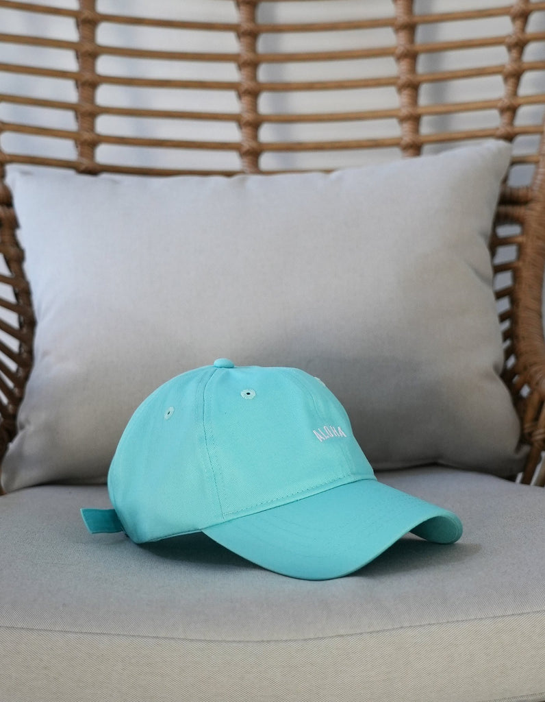Love Fitness Aloha Dad hat in the colors light teal with the word aloha embroidered on the front