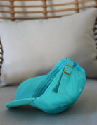 Love FItness Aloha Dad hat in the color teal and show casing the back of the hat with the beautiful bronze hardware on the adjustable strap