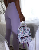 Model holding the Island Dreams mini back pack