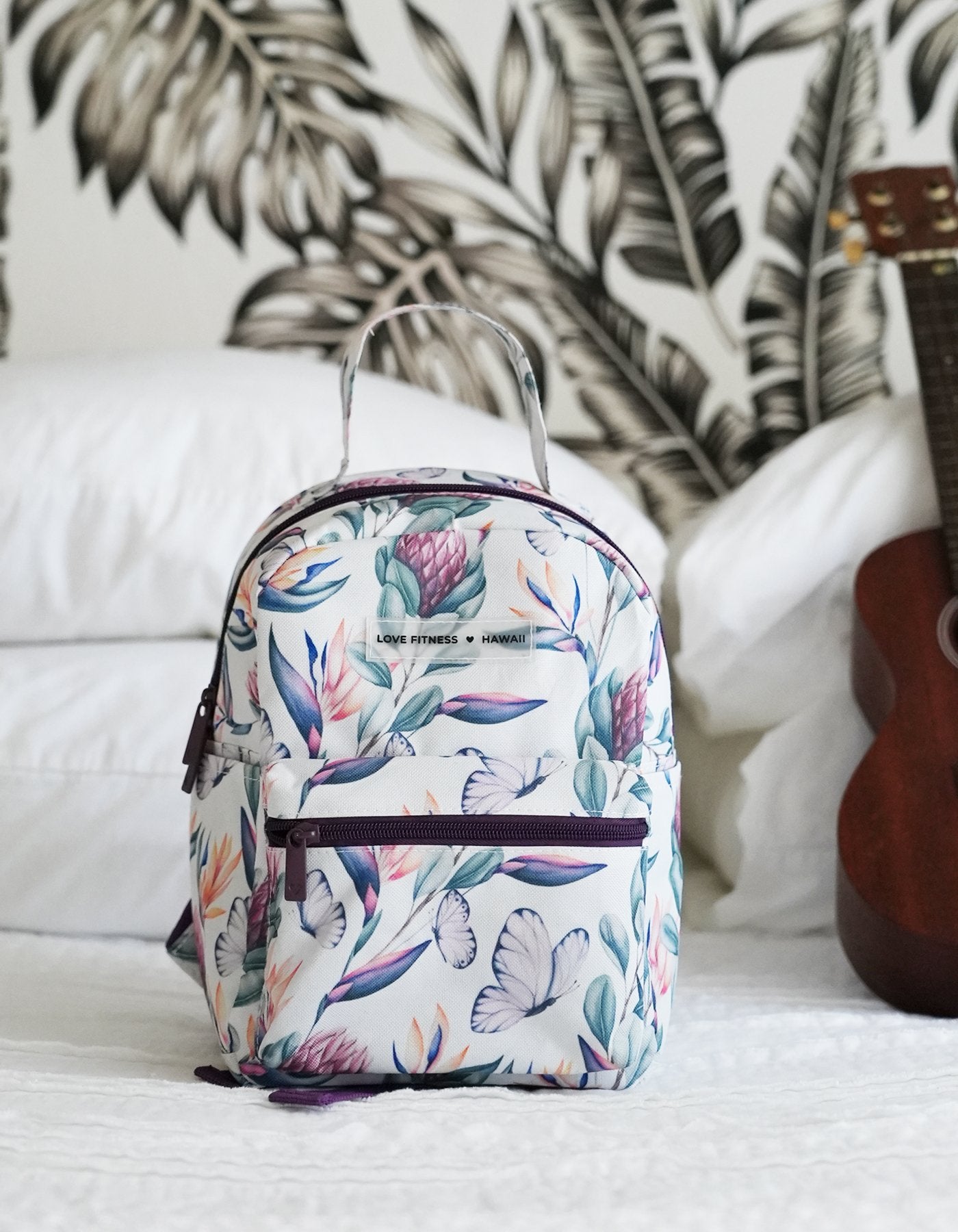 The cutest mini back pack for on the go eseentials with a gorgeous island dream print with tropical flowers and butterflies. Love Fitness 