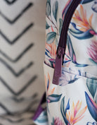 Side detailing of the mini back pack in the Island dreams print showing the zipper pulls with heart embossed detailing