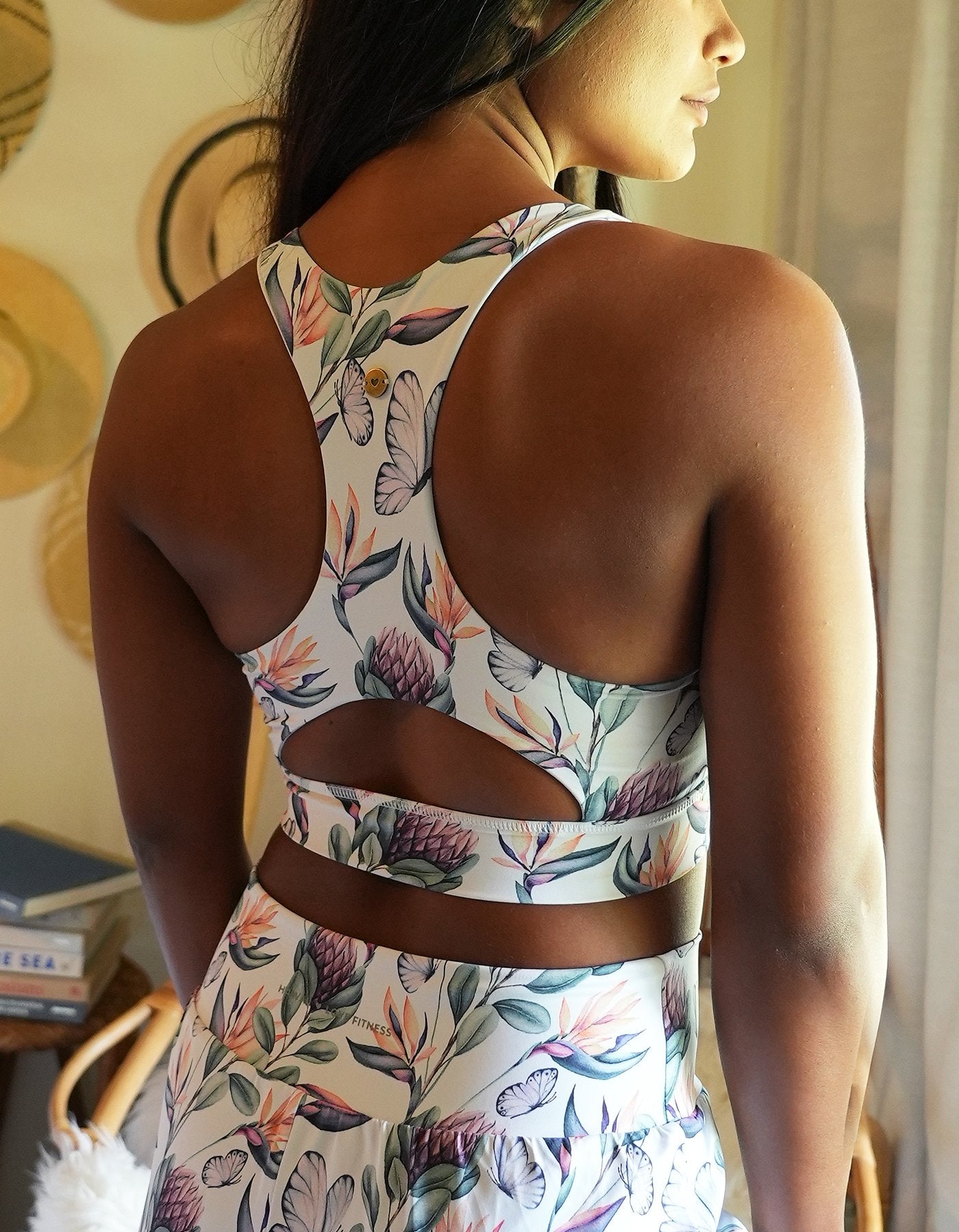 Love Fitness Apparel Island Dreams Sports bra. Showing a picture of the models back and the show cases the design of the back of the sports bra. Racerback and key hole opening.
