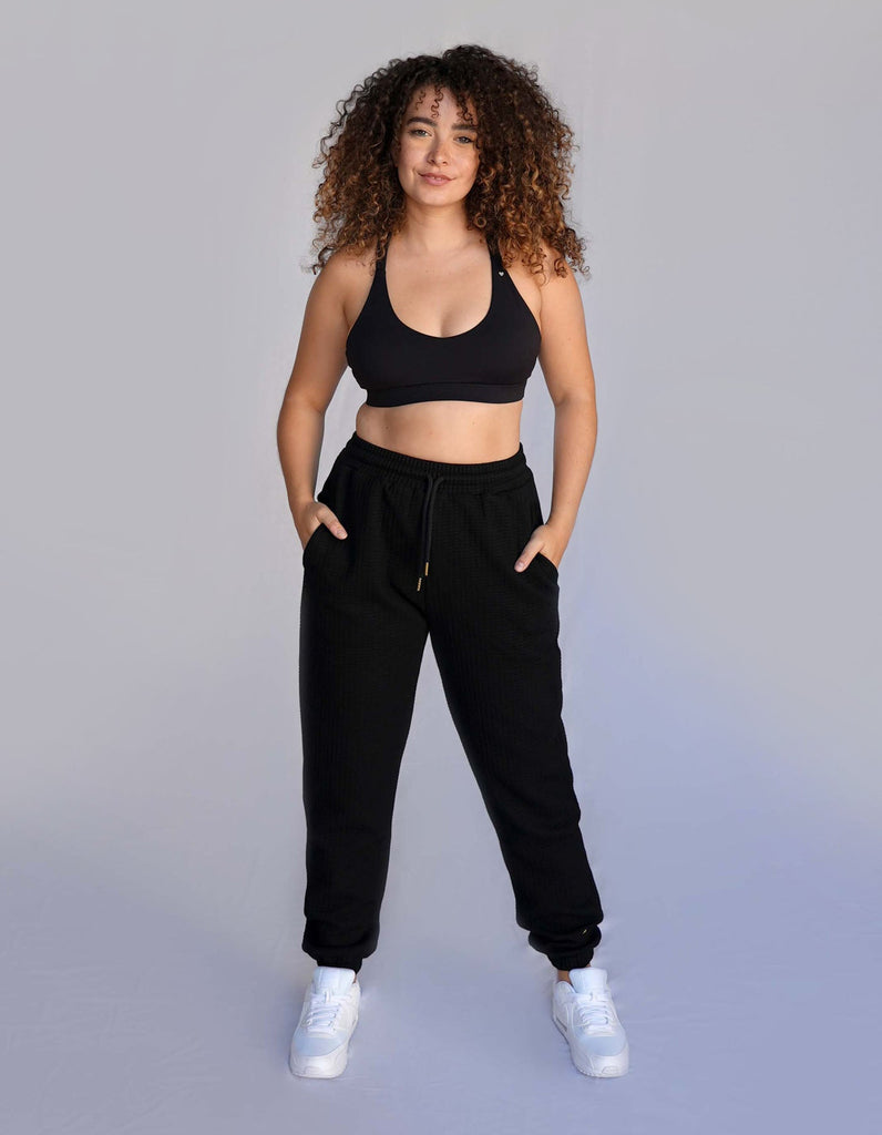 Love Fitness Phaedra Joggers in the color black. Waffle texture with pockets and drawstring to adjust the waistband.