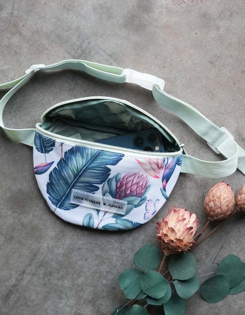 Love Fitness Tropical Paradise Fanny Pack featuring  a large zipper pocket to hold all your on the go essentials. Large straps that are adjustable