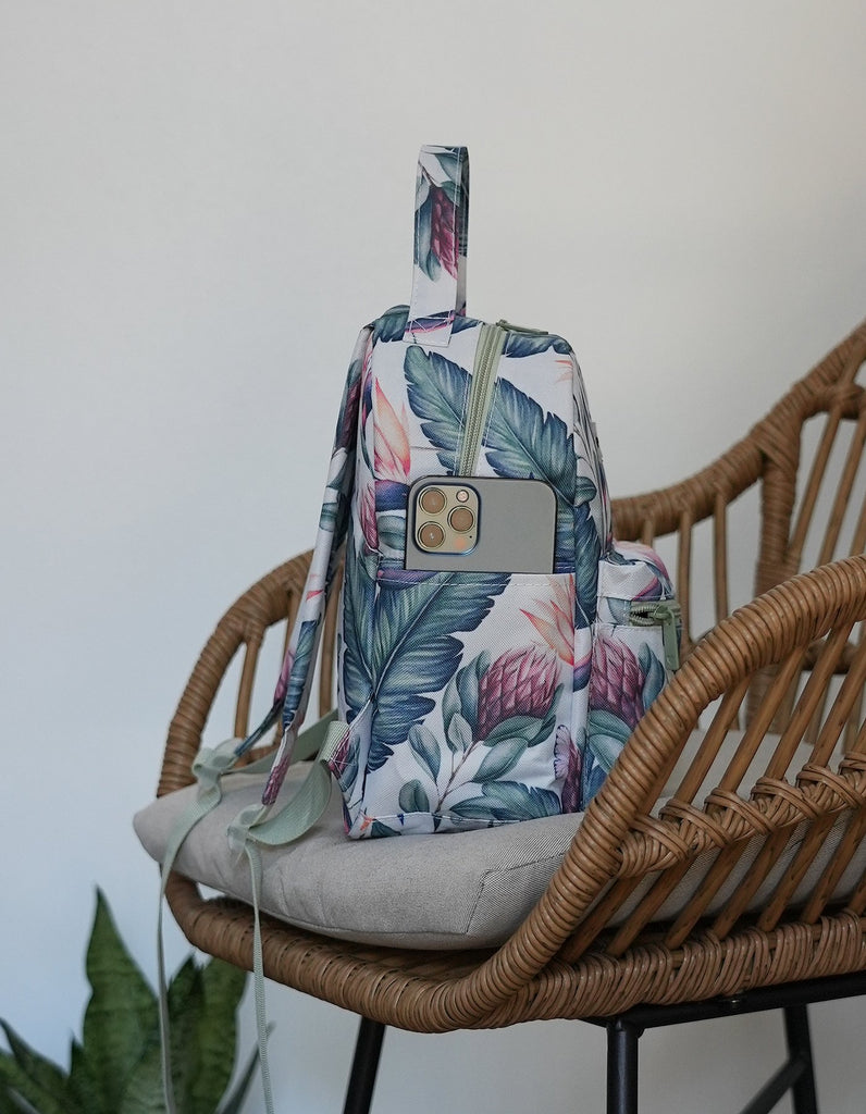 Love Fitness Tropical Paradise Mini Backpack and picture of the side of the back pack showing side pockets that can fit any size phone.